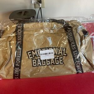 Gold “Emotional Baggage” duffle bag